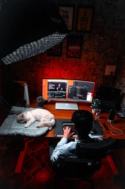 A sleek computer monitor shows web design projects, featuring creative visuals in a workspace.
